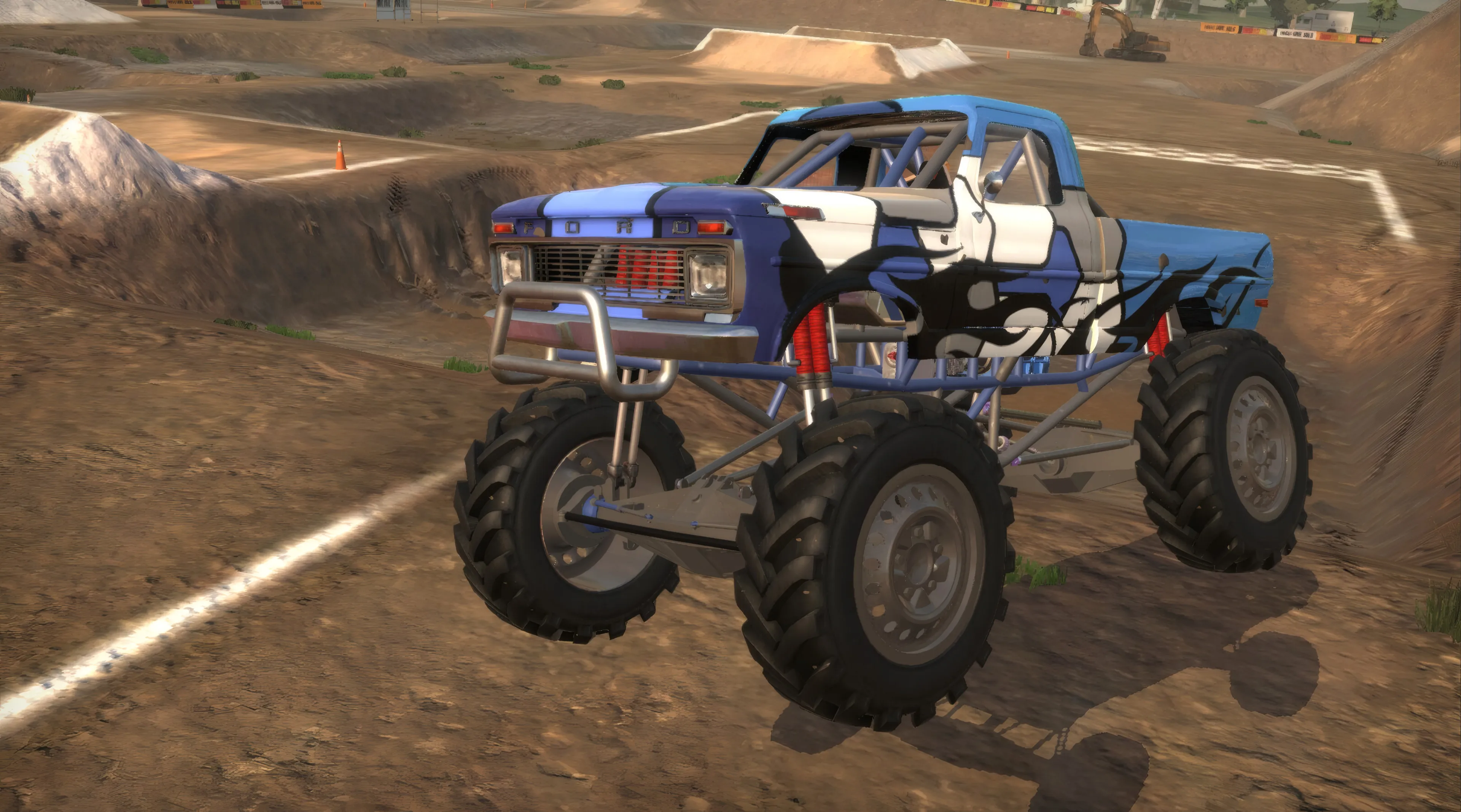 Blue and white lifted mud truck on a dirt track